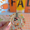 Video of the All The Fall Things MagSafe grip ring showing the cream watercolor pumpkin and pie print and the 180 degree rotating metal ring in motion.