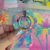 Pastel Paradise iridescent floral MagSafe phone grip ring with glowing lavender blue and coral petals compatible with iPhone and Samsung