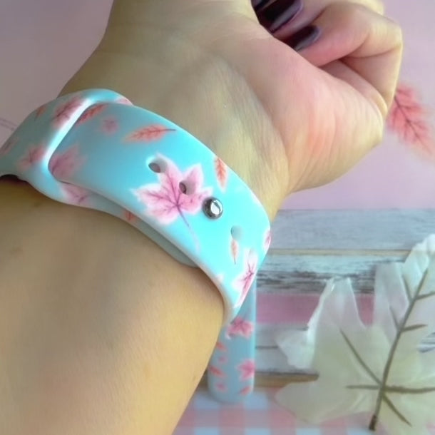 Video of the Autumn Breeze silicone Samsung Galaxy Watch band worn on the wrist and shown in both sizes, dusty blue with blush maple leaves.