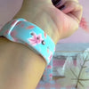 Video of the Autumn Breeze silicone Samsung Galaxy Watch band worn on the wrist and shown in both sizes, dusty blue with blush maple leaves.