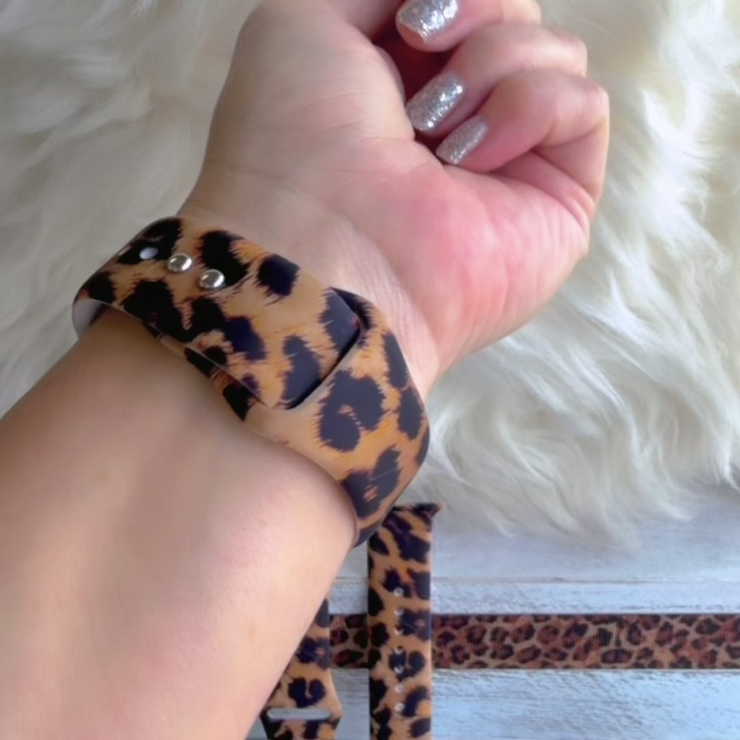 Rawr Mode Apple Watch band with bold tan and black leopard print pattern on white fur background
