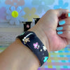 Flower Pop Apple Watch band with pastel flowers in pink, yellow, turquoise, and peach on black background with daisy decorations

