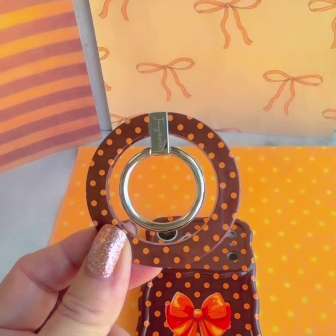 Video of the Spotted Looking Cute MagSafe grip ring showing the brown polka dot finish and the 180 degree rotating metal ring in motion.