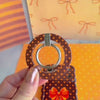 Video of the Spotted Looking Cute MagSafe grip ring showing the brown polka dot finish and the 180 degree rotating metal ring in motion.
