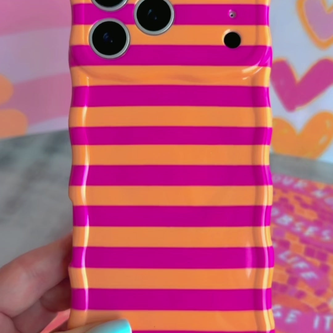 Wavy iPhone case featuring alternating horizontal stripes of hot pink and bright orange with a glossy finish.