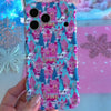 Video: turning the Sugarplum Square Wavy Luxe iPhone case in hand to show the pink Christmas village print and glossy wavy edges