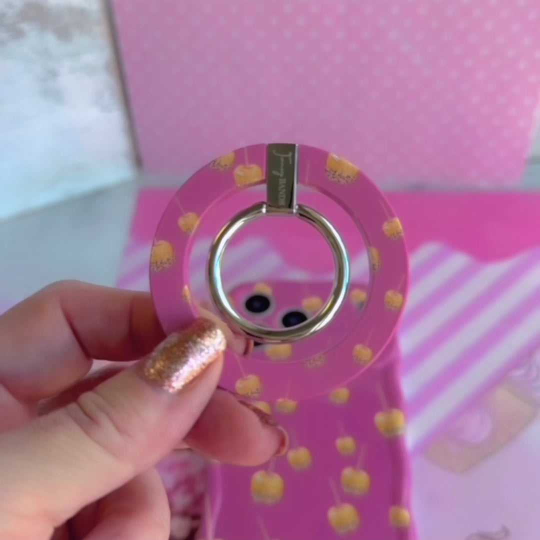 Video of the Caramel Coated Cutie MagSafe grip ring showing the pink caramel apple print and the 180 degree rotating metal ring in motion.