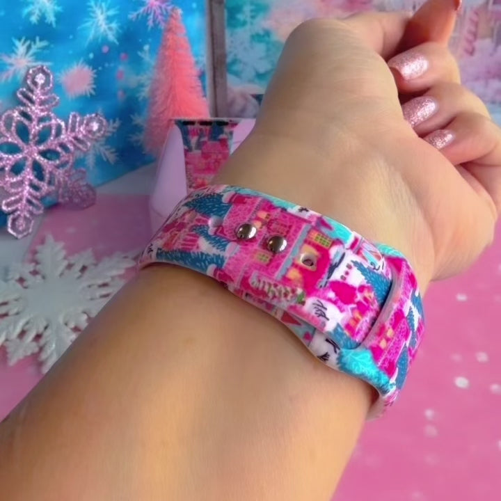 Video: Sugarplum Square Apple Watch band worn on the wrist, then both Christmas village straps shown on a pink jewelry box