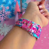 Video: Sugarplum Square Apple Watch band worn on the wrist, then both Christmas village straps shown on a pink jewelry box