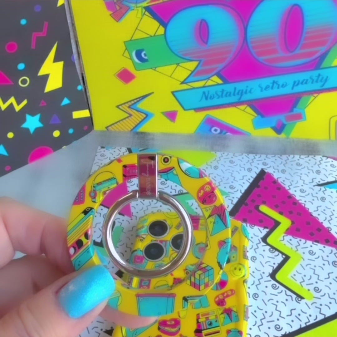 Oops It's the 90's retro pop art MagSafe phone grip ring with yellow background and colorful drawings of cassette players puzzle cubes and brick phones compatible with iPhone and Samsung