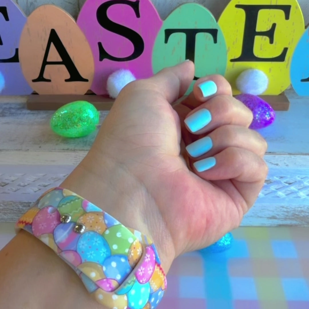Egg-stra Cute Apple Watch band with colorful pastel Easter eggs displayed with glittery eggs and Easter decorations
