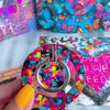 Rebel Wings graffiti butterfly MagSafe phone grip ring with electric blue butterflies, pink and orange paint splatters, and grunge street art design compatible with iPhone and Samsung