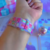 Video: No Peeking, Darling Apple Watch band worn on the wrist, then both pastel present straps shown on a pink jewelry box