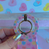 Conversation Hearts pattern MagSafe phone grip ring with pastel candy hearts and "Be Mine" text on pink background compatible with iPhone and Samsung
