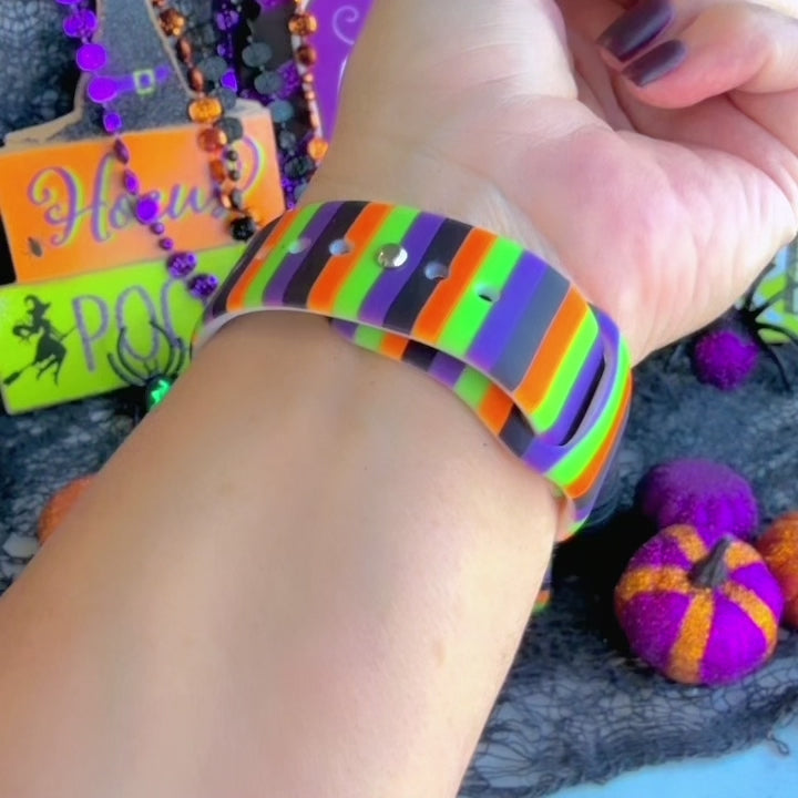 Video of the Main Witch Energy Samsung Galaxy Watch band worn on the wrist, showing the black, purple, green and orange stripes.
