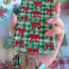 Video: Plaid Tidings & Bows scrunchie wrist strap worn on the wrist with the matching iPhone case hanging from the clasp