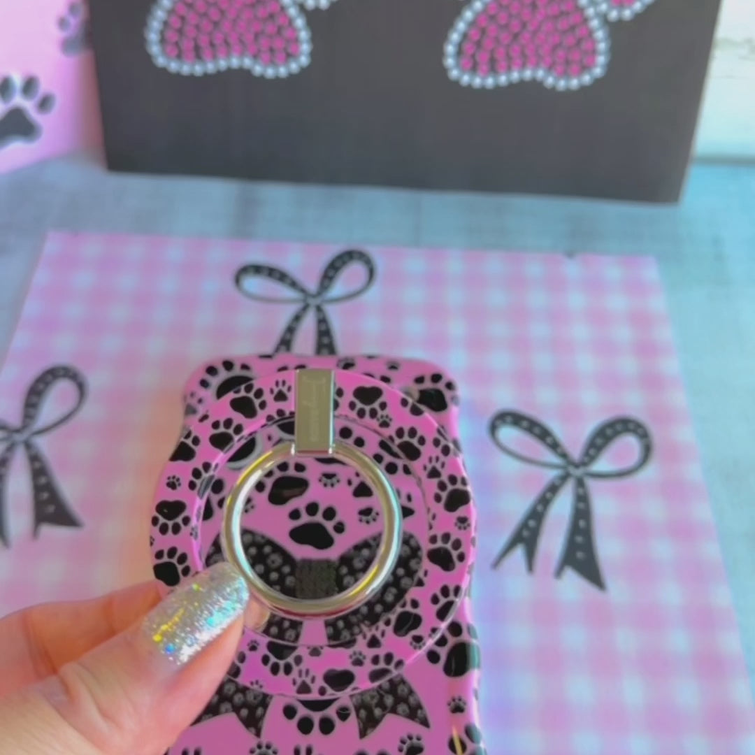 Pretty Little Paws pattern MagSafe phone grip ring with black paw prints on a pink background compatible with iPhone and Samsung