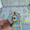 Pastel gingham phone ring grip used as kickstand for hands-free viewing