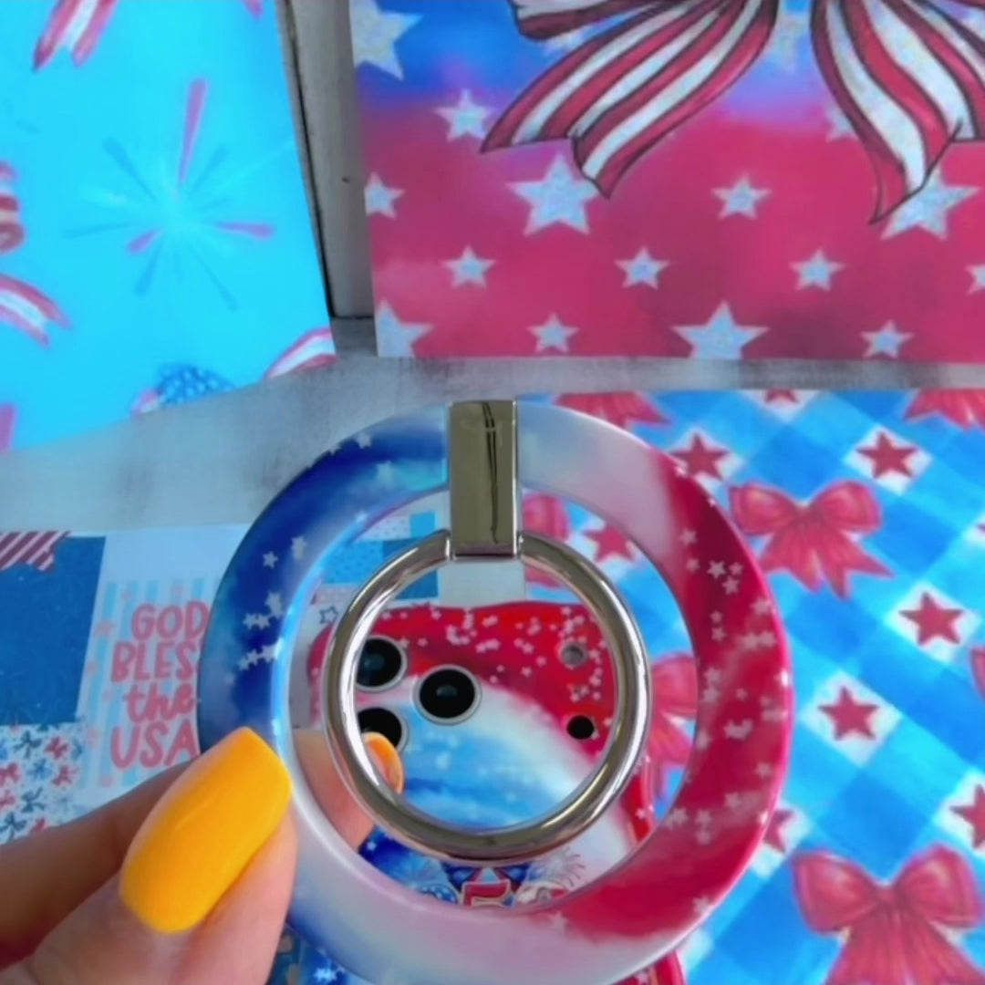 Sweet Freedom 250 patriotic watercolor MagSafe phone grip ring with swirling red white and blue pattern and white stars compatible with iPhone and Samsung