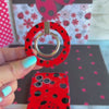 Ladybug pattern MagSafe phone grip ring with black polka dots on a vibrant red background compatible with iPhone and Samsung