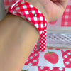 Video of the Red Barn Babe silicone Samsung Galaxy Watch band worn on the wrist and shown in both sizes, red and white gingham on the bias.
