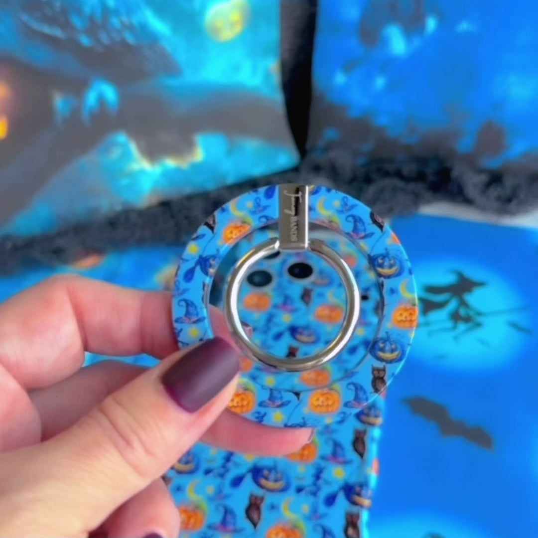 Video of The Bewitching Hour MagSafe grip ring on the back of the matching blue witch print iPhone case, rotating the silver ring and hooking a finger through it.