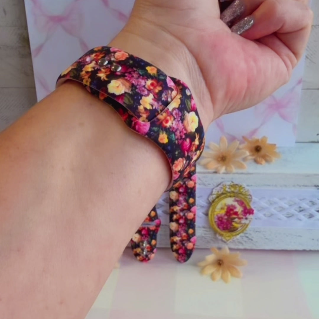 Twilight Bouquet Apple Watch band with vibrant pink, coral, and yellow flowers on black background with white daisies
