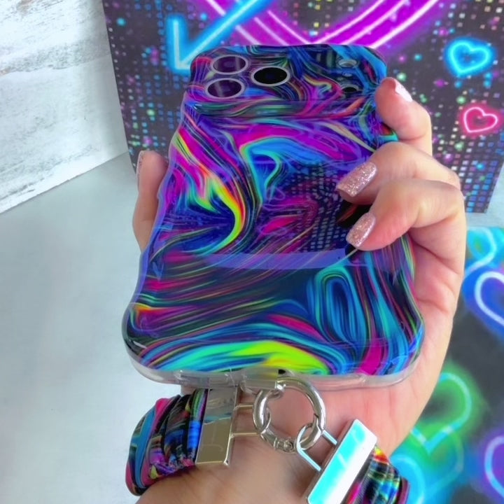 Video of the Neon Taffy Scrunchie Phone Wrist Strap worn on the wrist and clipped to the matching neon marble phone case, showing the gathered fabric and silver clasp.