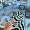 Fifth Ave. Flow monochromatic fluid wave pattern MagSafe phone grip ring with black and white swirling design compatible with iPhone and Samsung