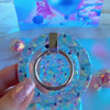 Video: Twinkle All The Way grip ring shown close up, snapped onto the matching case and held with one finger through the silver ring