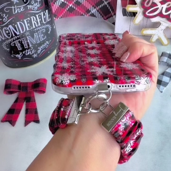 Video: wearing the Buffalo Plaid Snowflake scrunchie phone wrist strap on the wrist with an iPhone clipped on