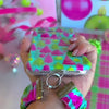 Video: Merry & Bright, Totally! scrunchie wrist strap worn on the wrist with the matching iPhone case hanging from the clasp