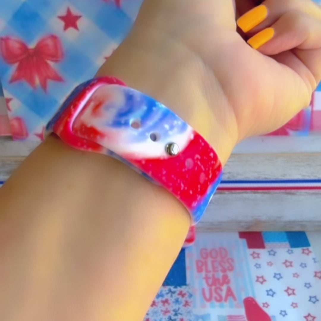 Sweet Freedom 250 silicone Samsung Galaxy Watch band celebrating America's 250th anniversary with "250 Years 1776" emblem, American flag, fireworks, red bow, and red, white, and blue tie-dye swirl with star sparkle, shown displayed and worn against a patriotic 4th of July backdrop.