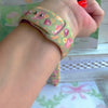 Tea Time Delight Apple Watch band with pink teapots and teacups on yellow-green background with watercolor tea party backdrop
