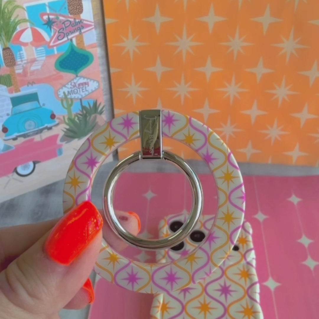 Desert Starburst retro mid-century MagSafe phone grip ring with pink and orange starbursts on a cream background compatible with iPhone and Samsung