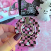 Video of the Hey Boo, Looking Cute MagSafe grip ring on the back of the matching pink checkerboard ghost case, rotating the silver ring and hooking a finger through it.