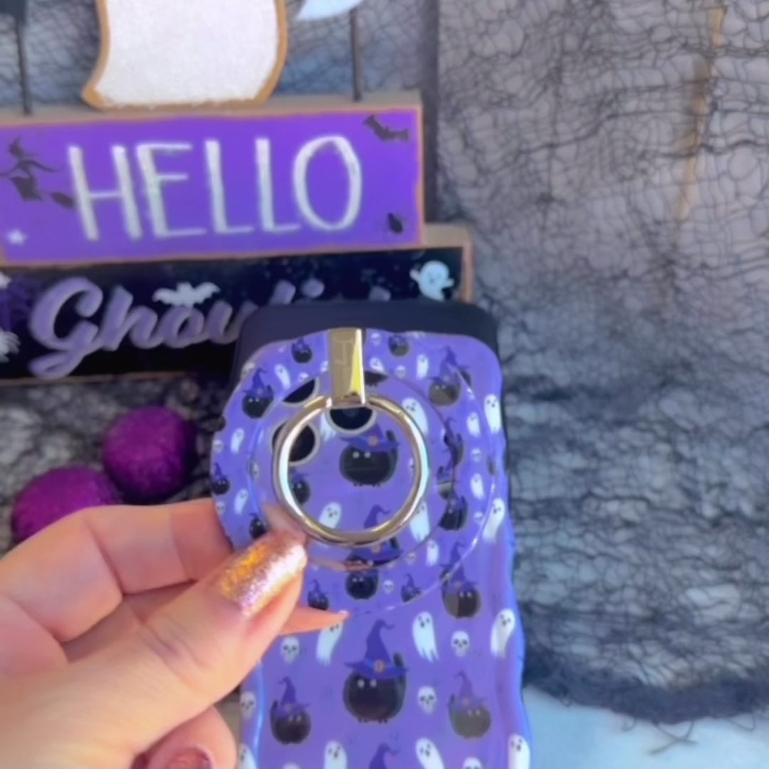 Video demo of the Ghostly Whisker's MagSafe grip ring snapping onto the matching lavender ghost and cat case, then used as a finger hold and kickstand.