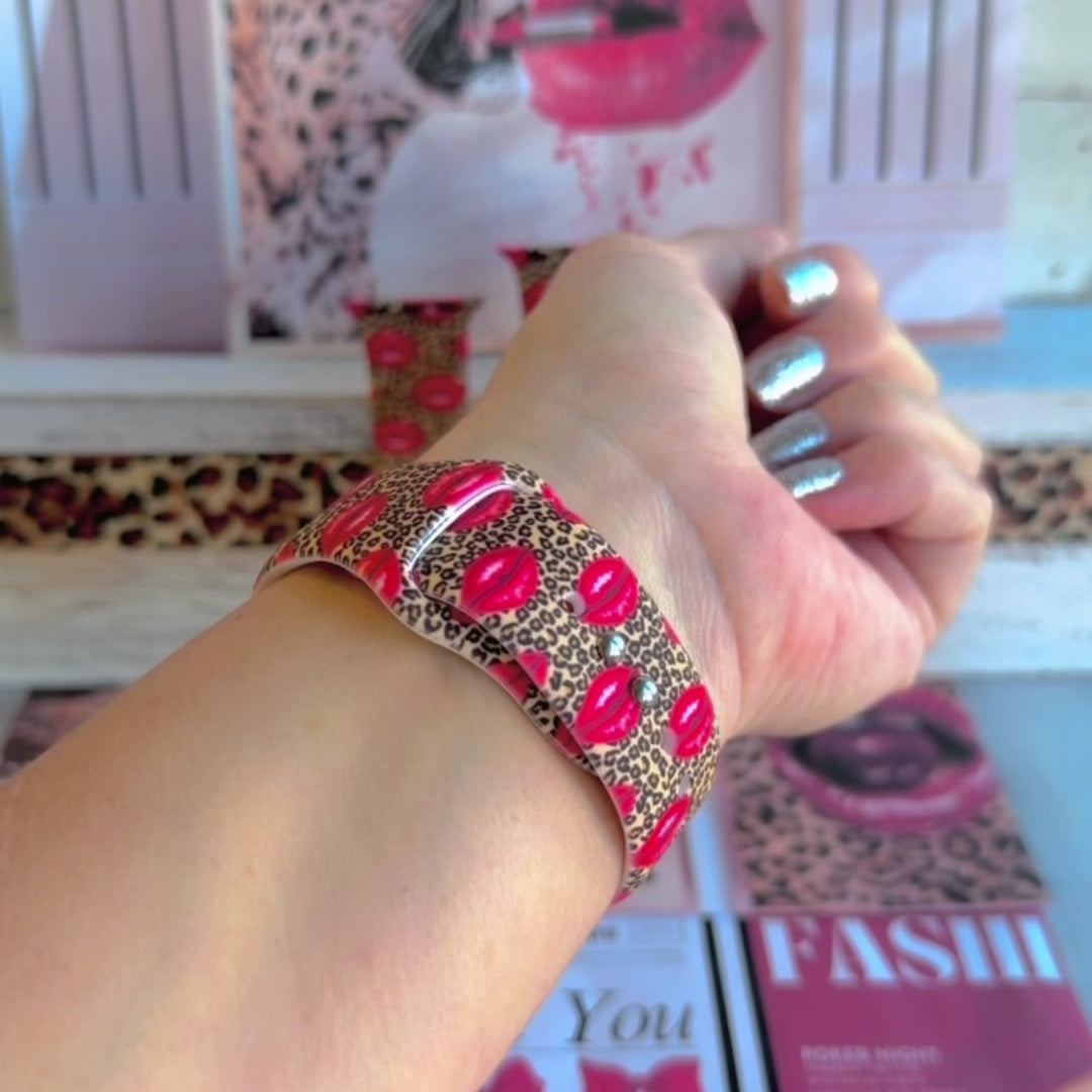 Kiss Me Leopard Apple Watch band with red glossy lips on tan leopard print styled with beauty and fashion decor
