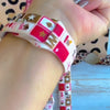 Wild Cherry Apple Watch band with retro checkerboard pattern featuring cherries, lips, and leopard print in red and cream
