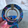 Neon Taffy matching set video: silver MagSafe grip ring snapped onto the swirled neon marble iPhone case, then the matching scrunchie wristlet clipped to the case and worn on the wrist