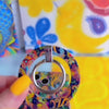 Paisley Birdsong bohemian MagSafe phone grip ring with intricate jewel-toned paisley, flowers, and birds on a deep navy background compatible with iPhone and Samsung