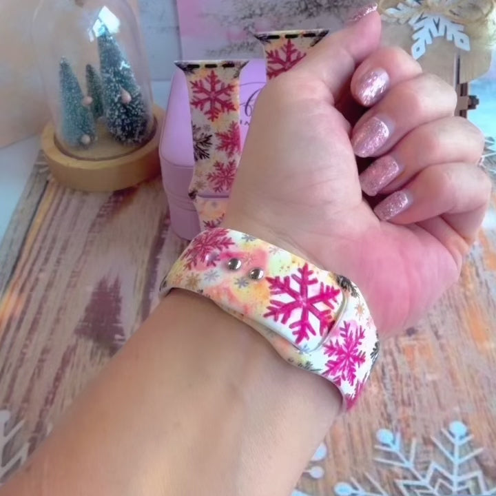 Video: Champagne Snowfall Apple Watch band worn on the wrist, then both snowflake straps shown on a pink jewelry box