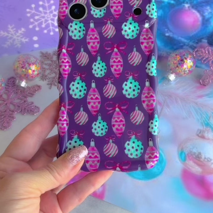 Video: turning the Just One More Ornament Wavy Luxe iPhone case in hand to show the ornament print and glossy wavy edges