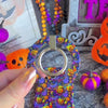 Video of the full Jack-O-Lantern Jive matching set — the Wavy Luxe MagSafe case, the MagSafe grip ring and the scrunchie wrist strap shown together.