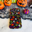 Spooky Wavy Luxe MagSafe iPhone case laid flat on black spiderweb mesh with an orange jack-o-lantern pail and felt pumpkins