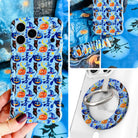 The Bewitching Hour iPhone Matching Set: hand-held periwinkle blue MagSafe case with witch hats, owls and jack-o'-lanterns, matching scrunchie wrist strap, and MagSafe grip ring